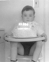 Bradford Robert McCormick (BMcC) jammed into his high chair on his 5th birthday; count the candles: 1, 2, 3, 4, 5. ~ A psychotherapist explained to me that this was not normal. ~ Do I look like a happy camper?