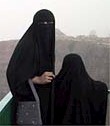 Two Saudi women, chadored.